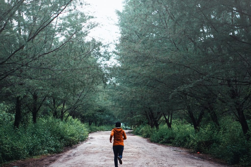 person running through forest