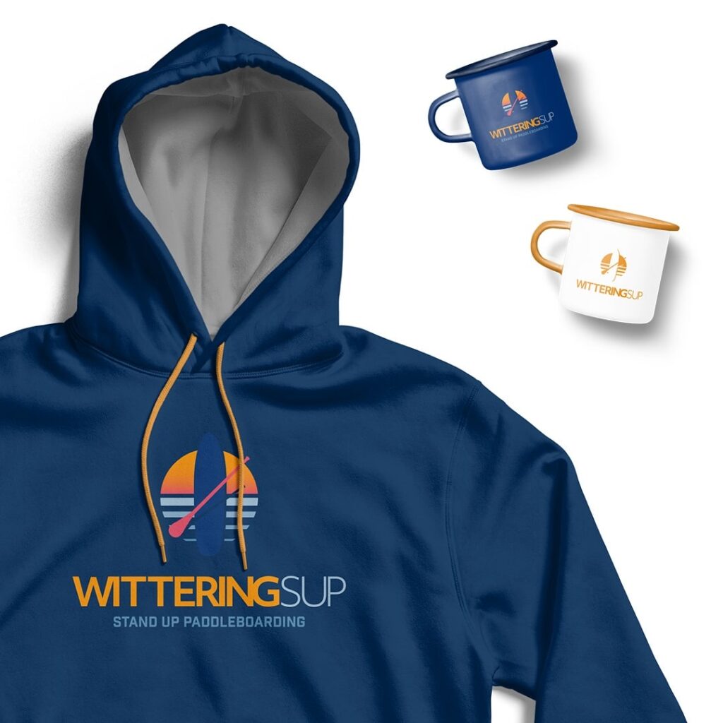 brand development for Wittering SUP, blue hoodie with logo and a blue mug and a white mug to the right hand side